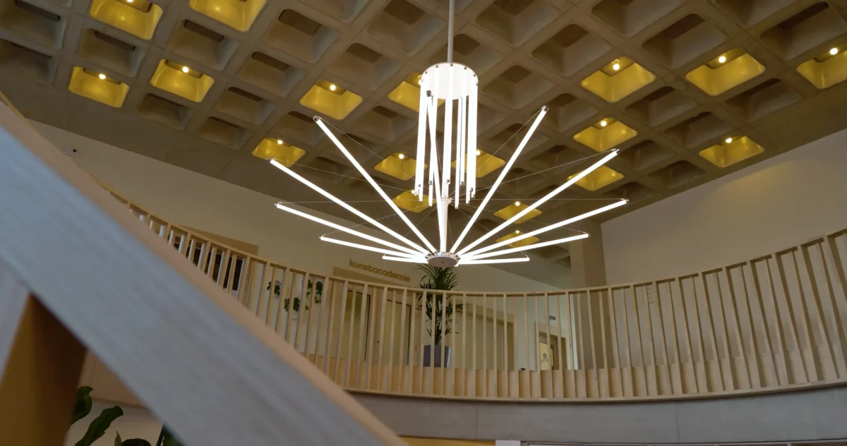 A custom chandelier of slender LED rods suspended in the atrium of the Centrum De Faar library.