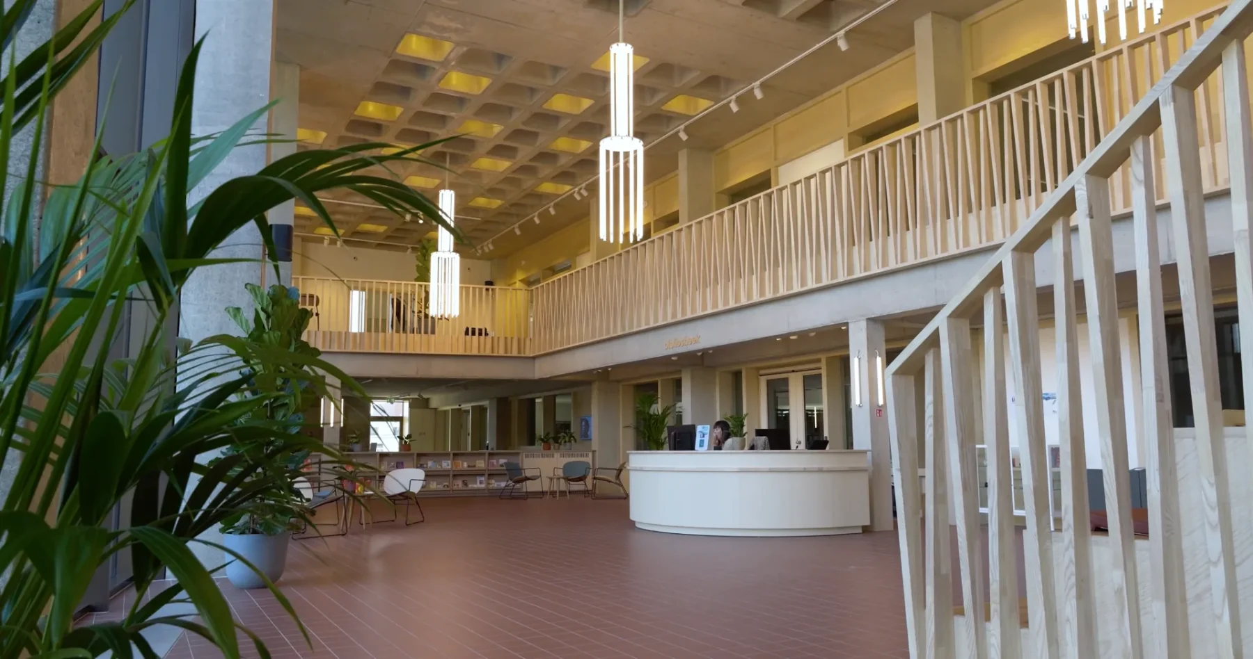 The library interior at Centrum De Faar, lit by the custom chandelier across the open atrium.