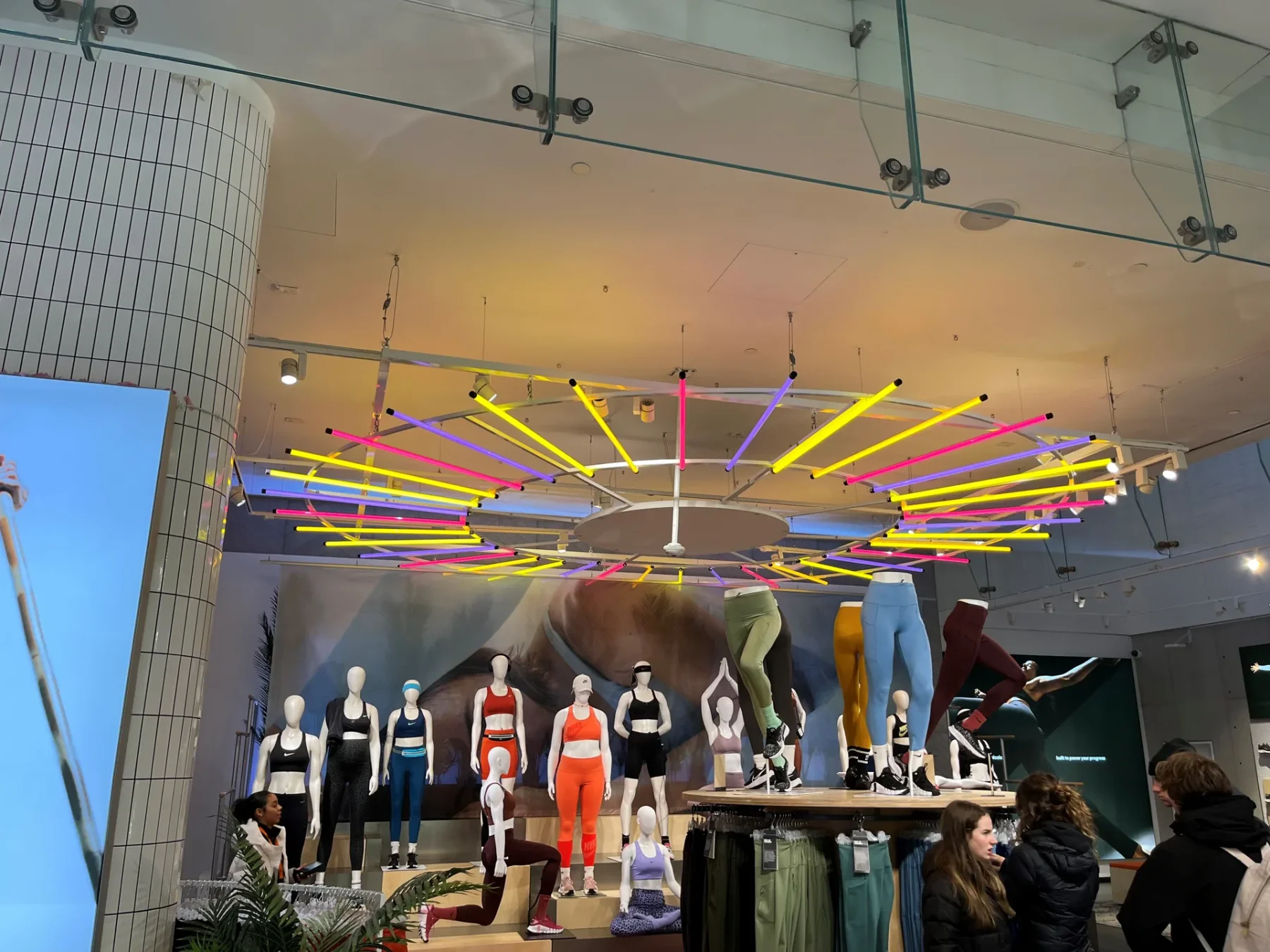Coloured display lighting over the Nike Town retail floor, showing the interchangeable sleeve system in use.
