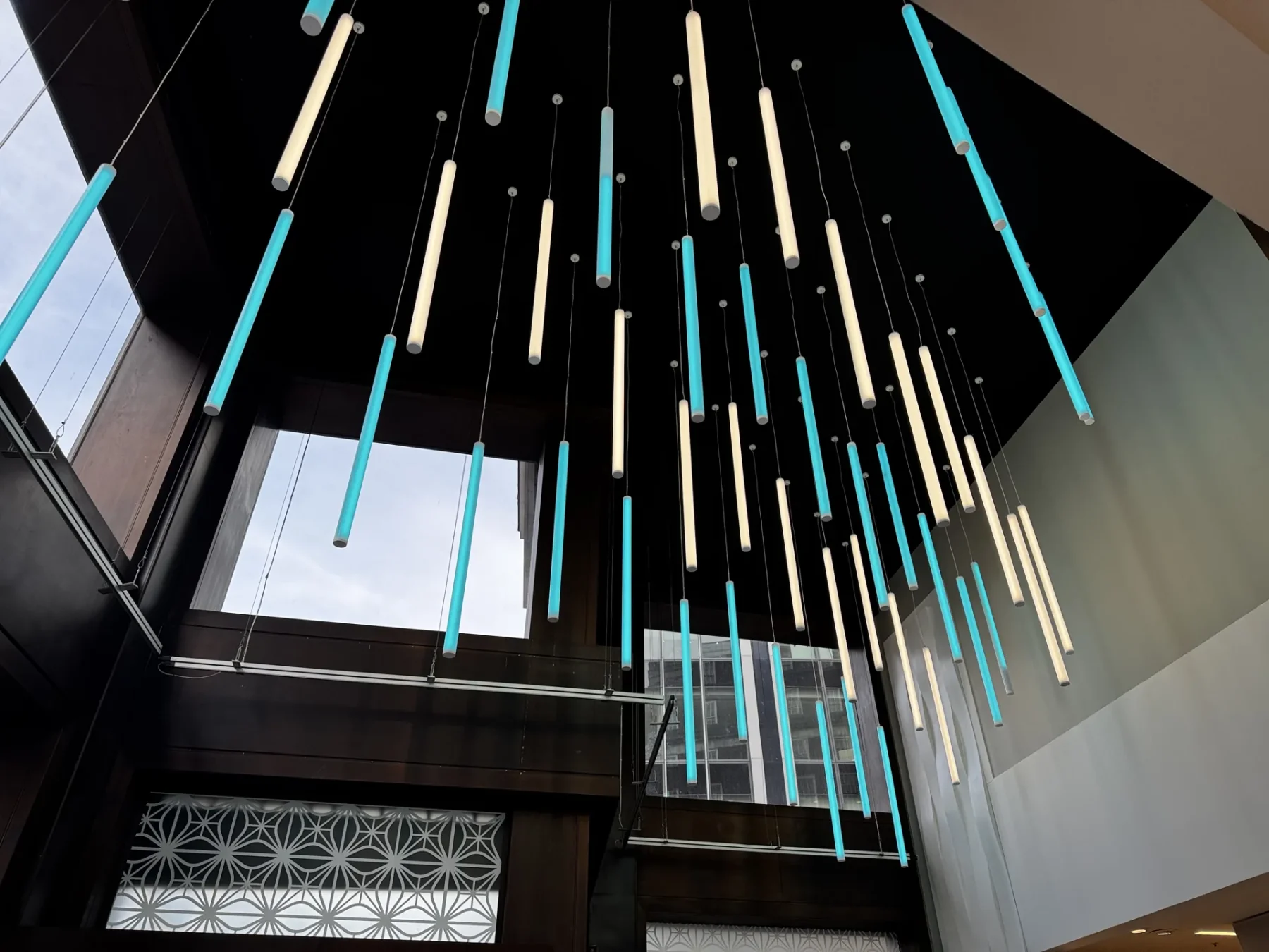 The completed Primark entrance foyer illuminated by the bespoke brand-matched feature lighting.