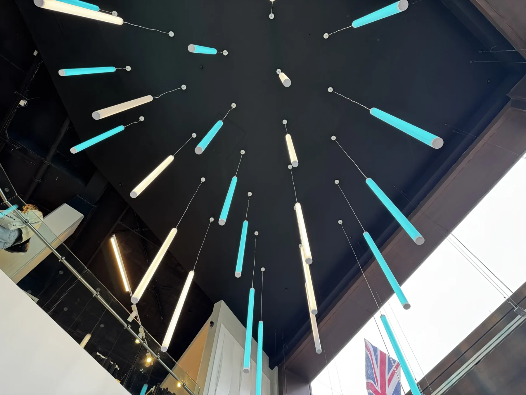 Upward view of the Primark foyer feature lighting radiating from the ceiling above the entrance.